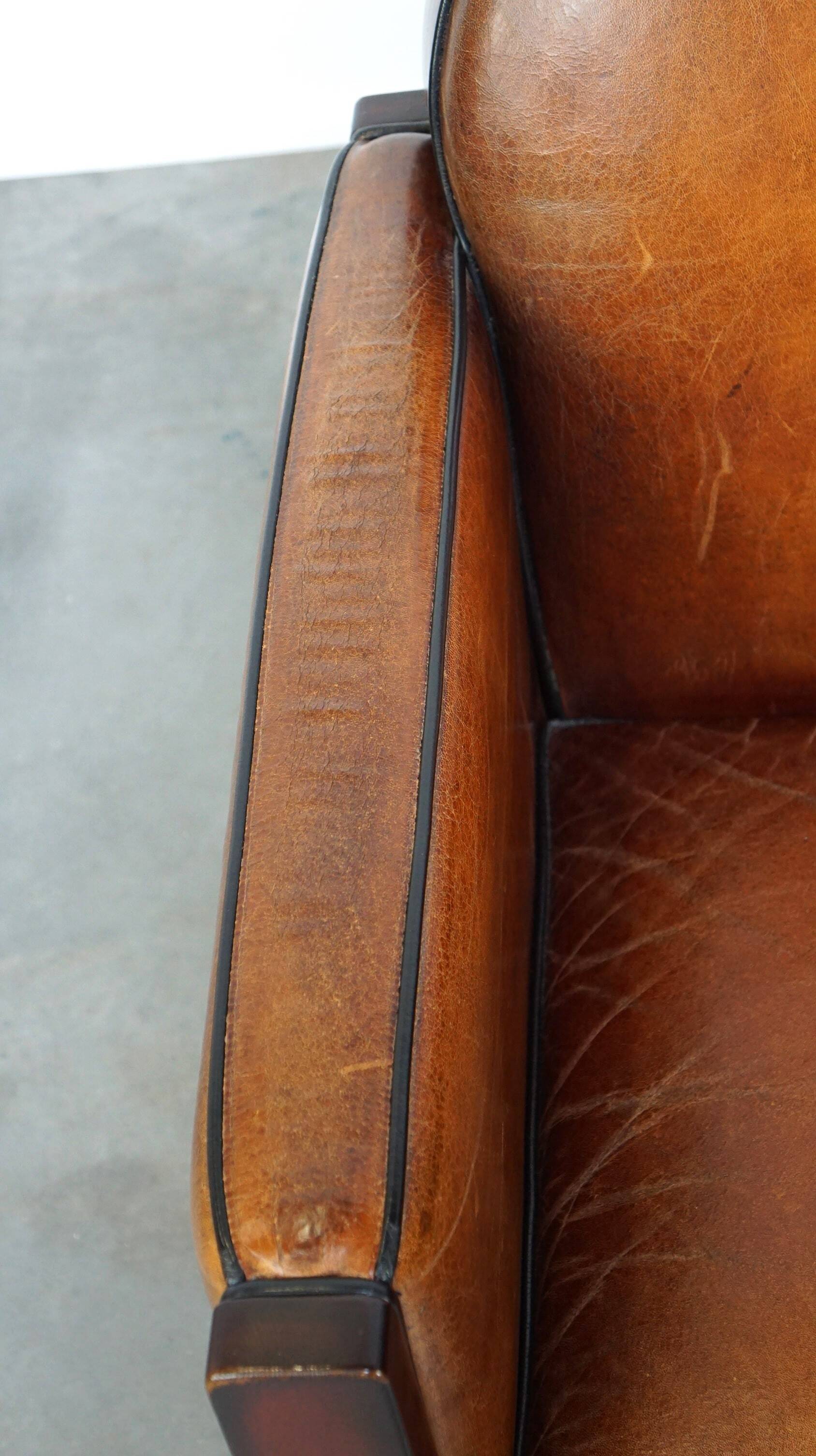 Sheepskin Art Deco design armchair with wood and beautiful cognac-colored leather