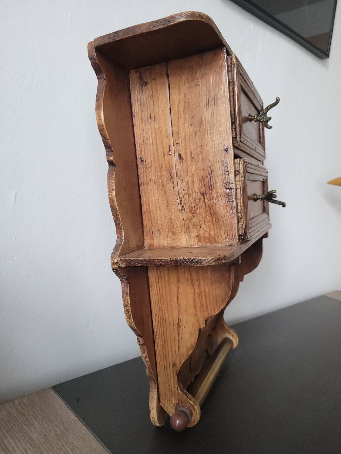 Small antique wall shelf with a drawer in light solid wood.