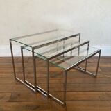 Modernist work, suite of three trundle tables in chromed metal and glass