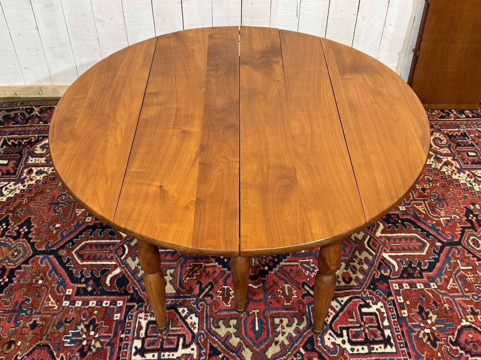 Round cherry wood table, 6 feet, Louis Philippe style with 2 extensions.