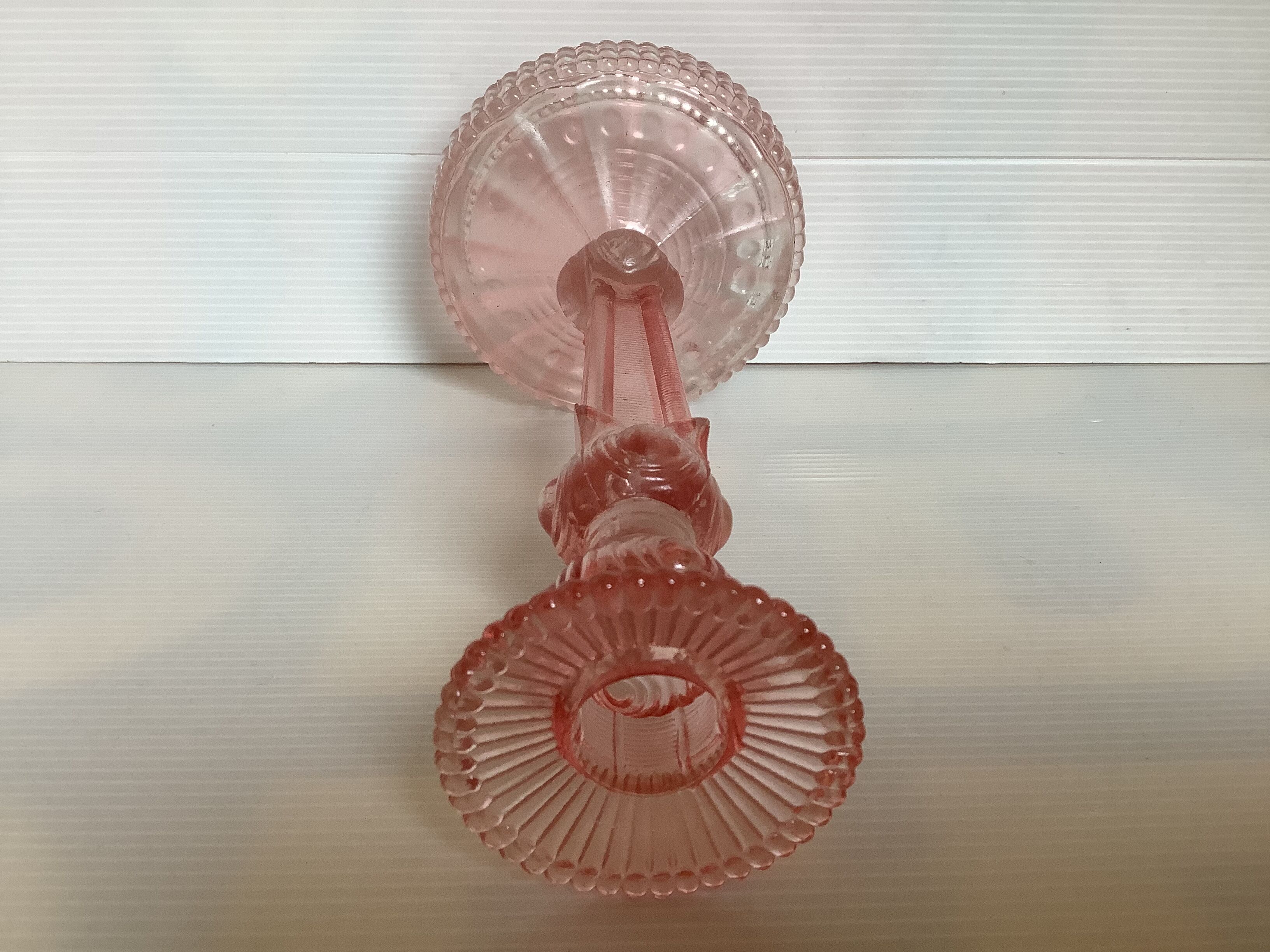 Old pink glass candlestick in Rosaline style.