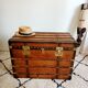 Restored varnished wooden antique travel trunk