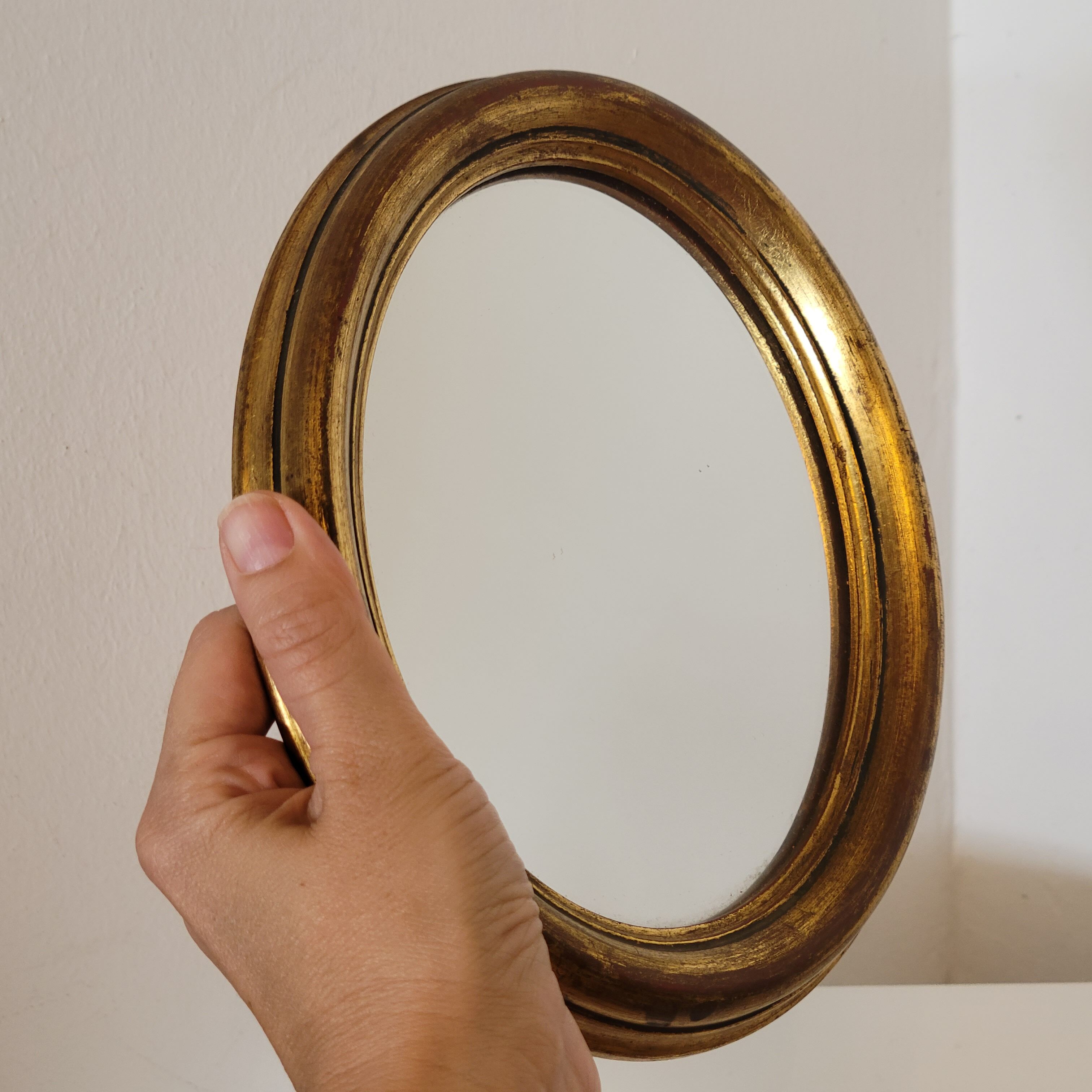 Old small oval mirror gilded wooden frame 22 X 17 X 2 cm.