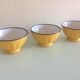 Suite of three yellow ribbed bowls with blue / vintage 70s border