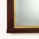 Antique Empire fireplace mirror in mahogany with a bronze frame, Italy, 19th century.