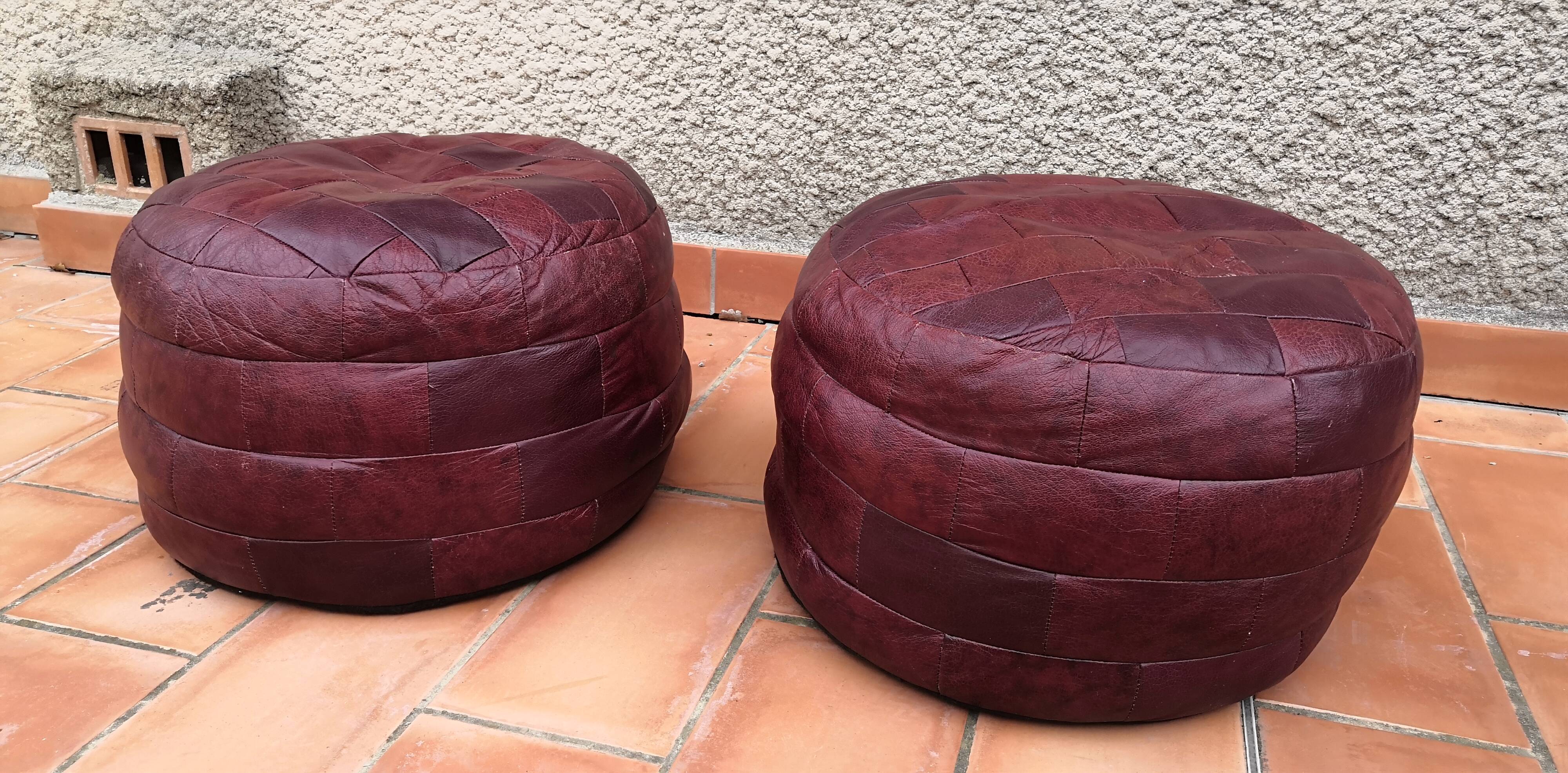 Pair of vintage poufs in burgundy leather patchwork, 1970