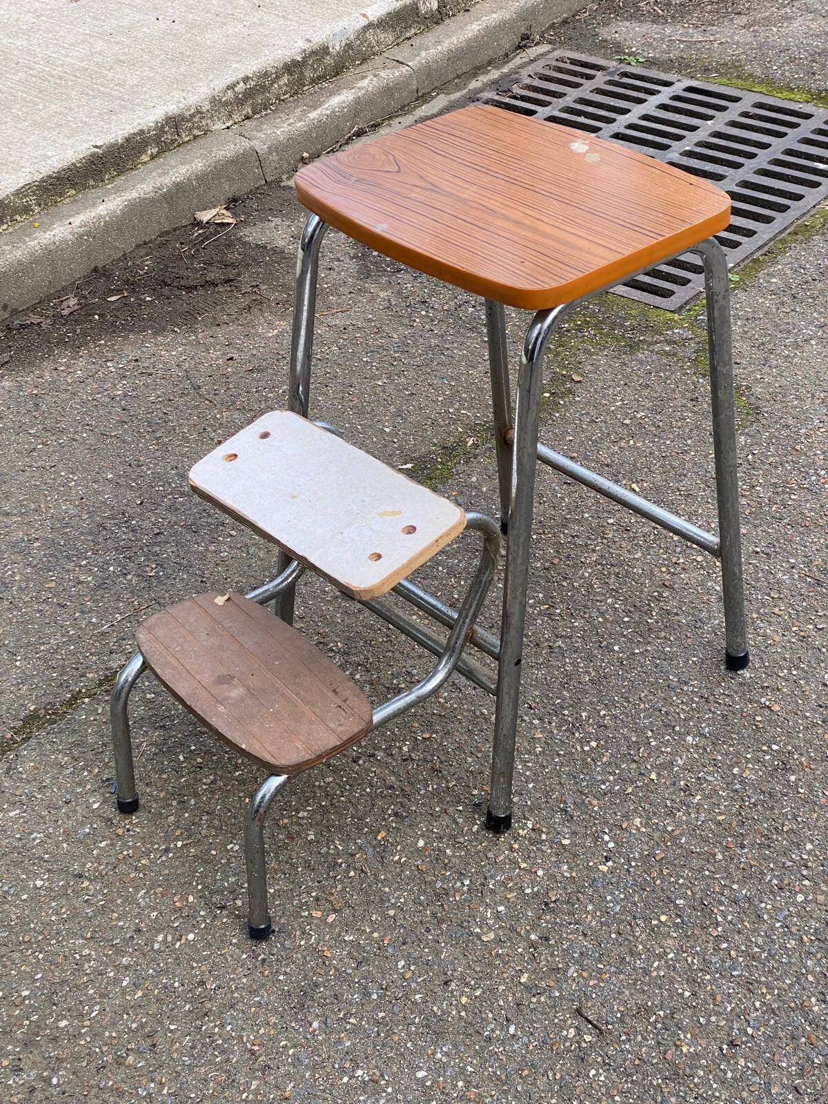 Folding stool in formica with a wood effect.