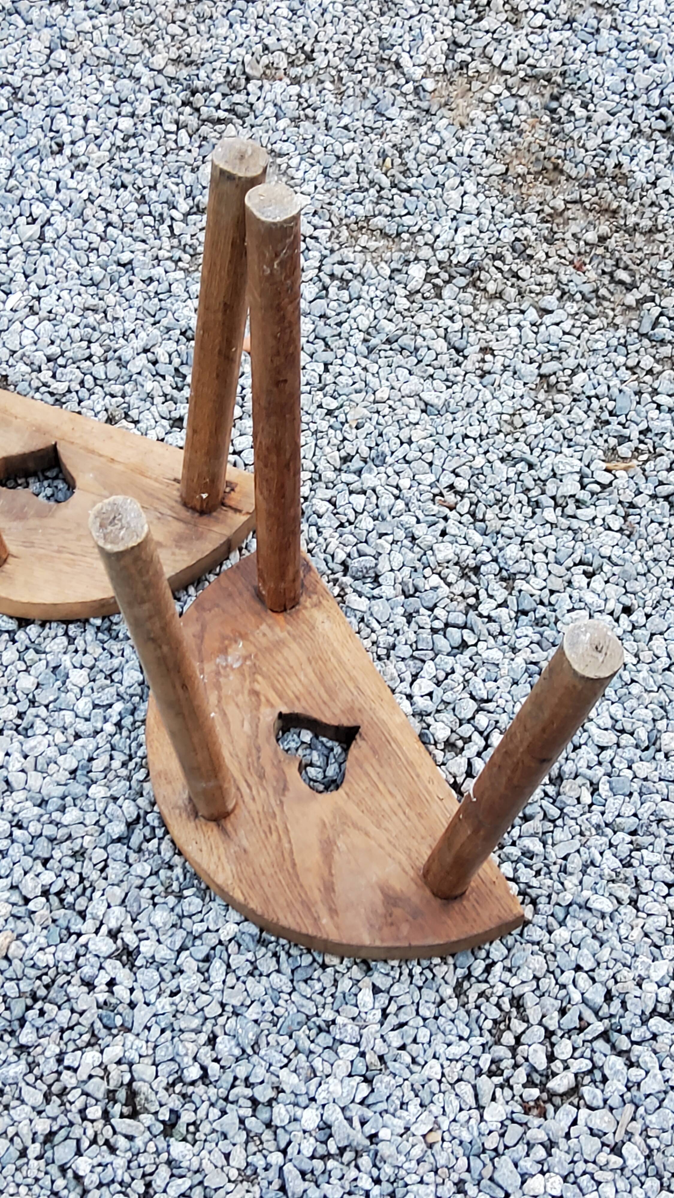 Pair of shepherd's stools in tripod oak décor in the heart