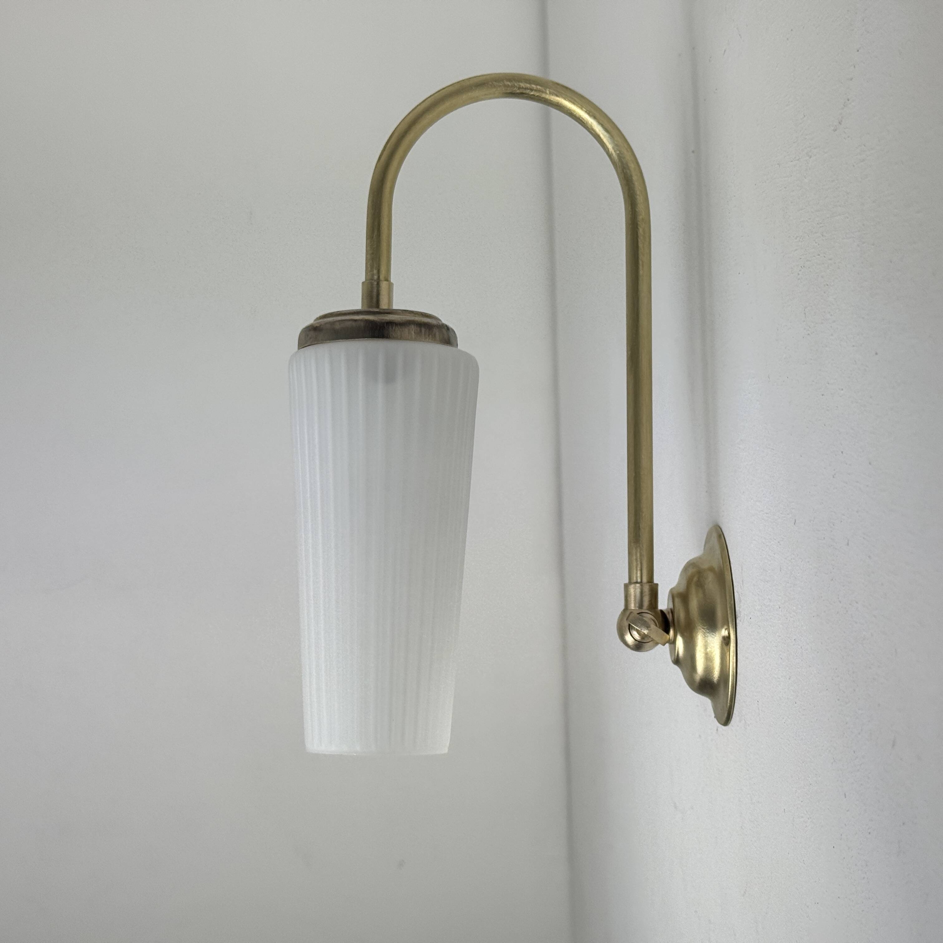 A pair of vintage opaline and brass wall lights