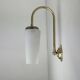 A pair of vintage opaline and brass wall lights