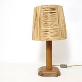 Lamp base in saddle stitched leather and raffia lampshade.
