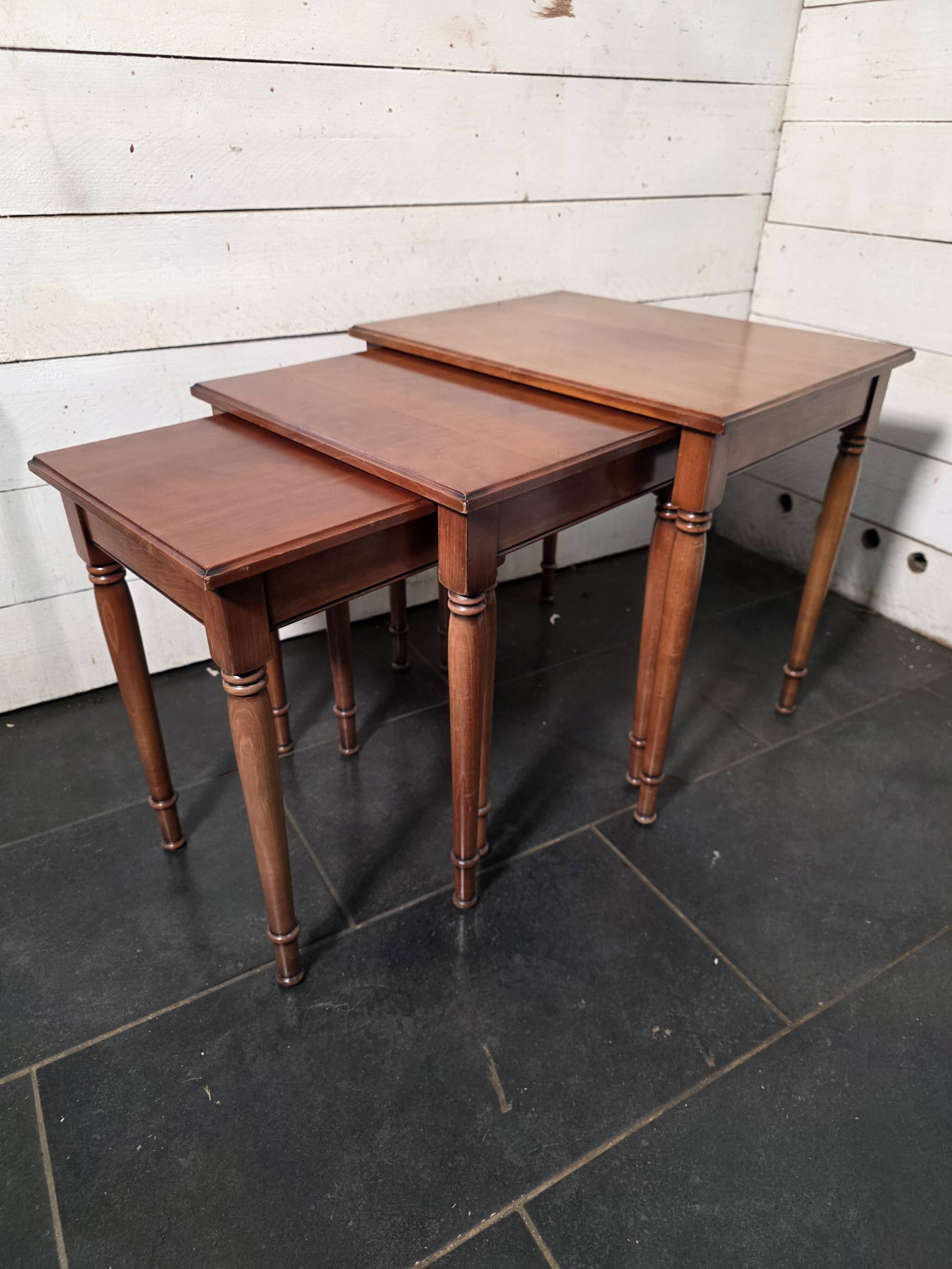 Nest of tables in solid cherry wood from the mid-20th century.