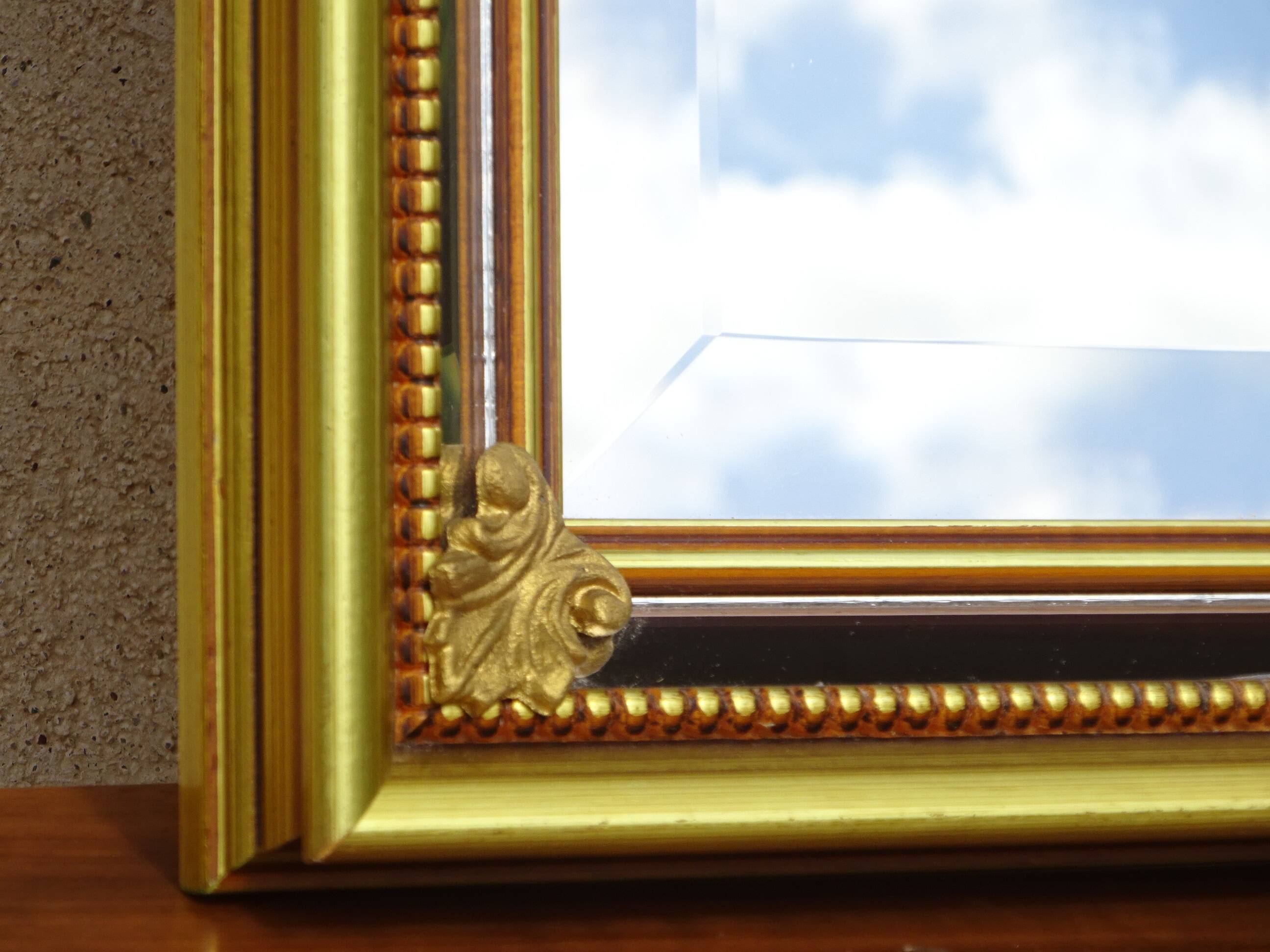 Vertical mirror, gold frame with beading.