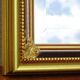 Vertical mirror, gold frame with beading.