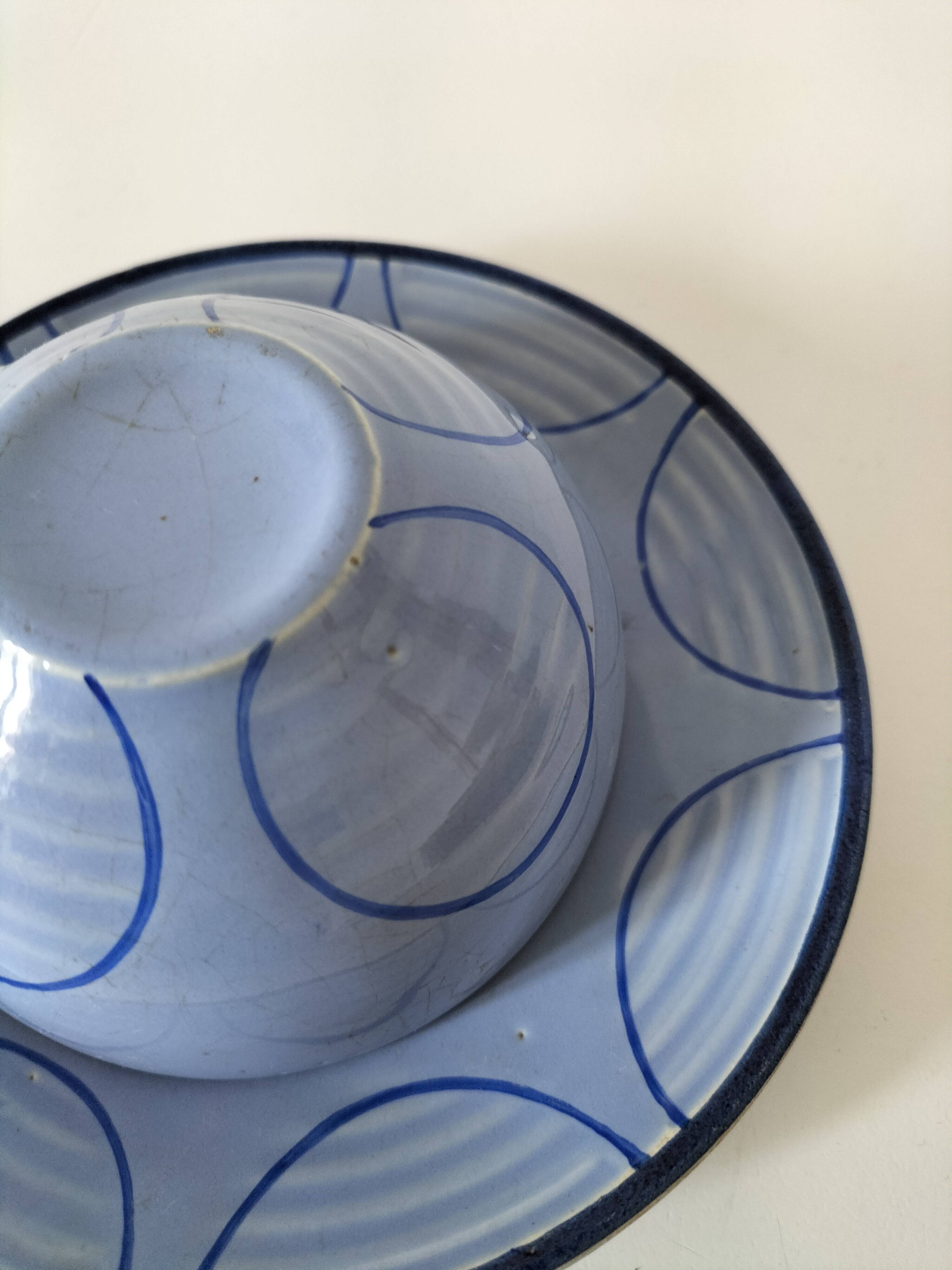 A pair of glazed ceramic cups and saucers from the 60s-70s.