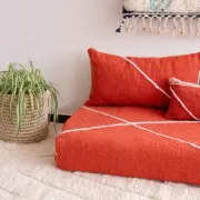 Handmade Moroccan floor cushion in orange cotton.