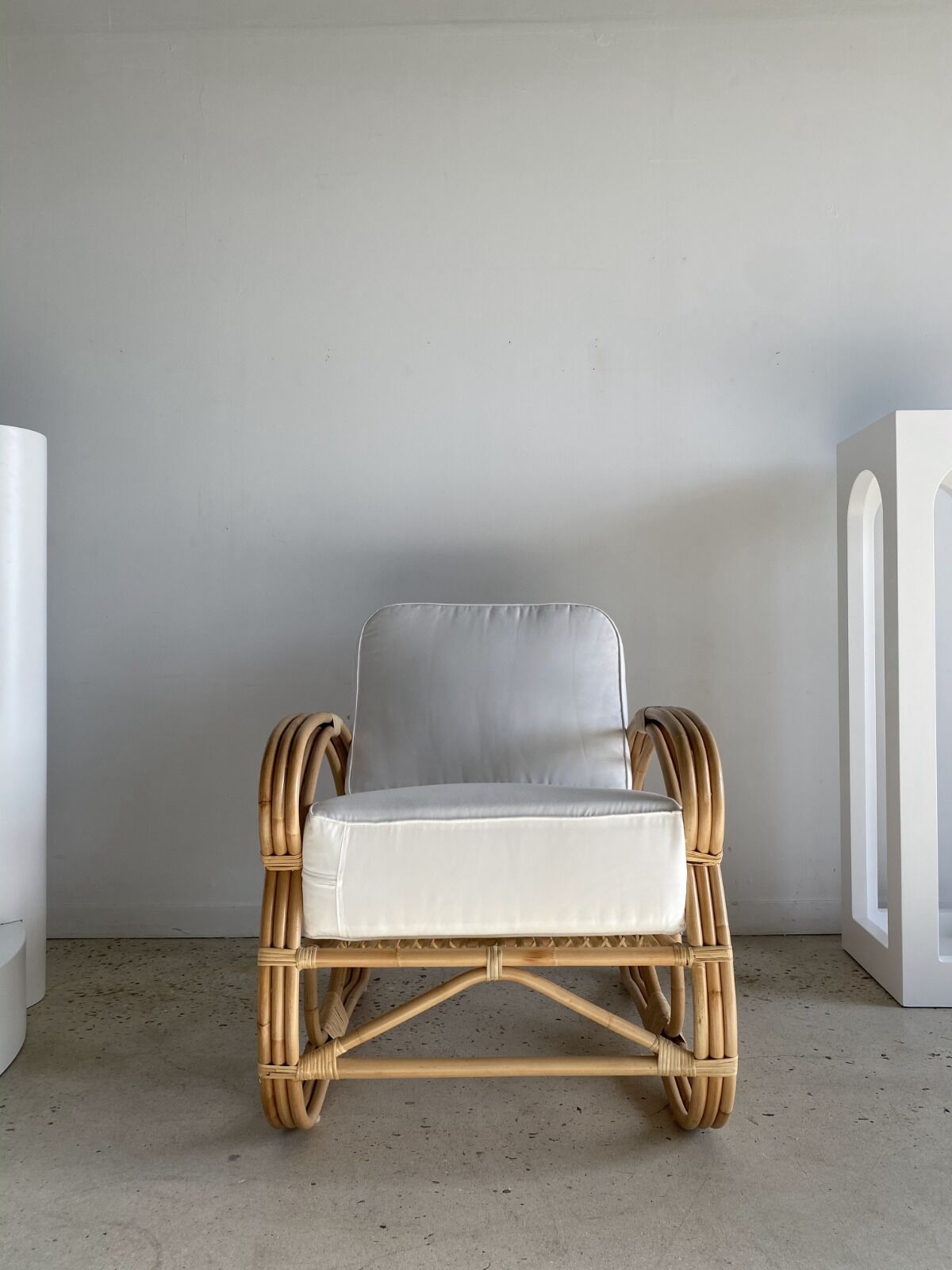 Large rattan rest chair and white cushions