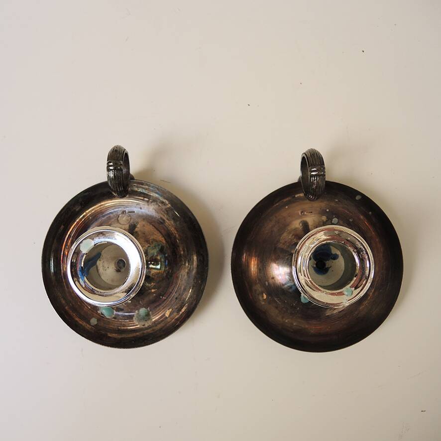 2 antique metal candlesticks with handles