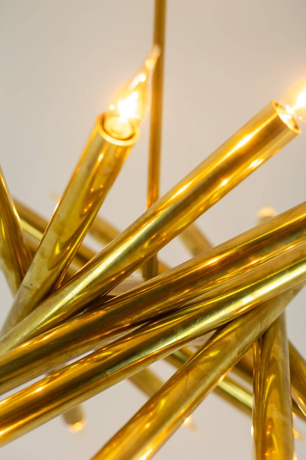 Pair of 24-light patinated brass chandeliers. 1980s.