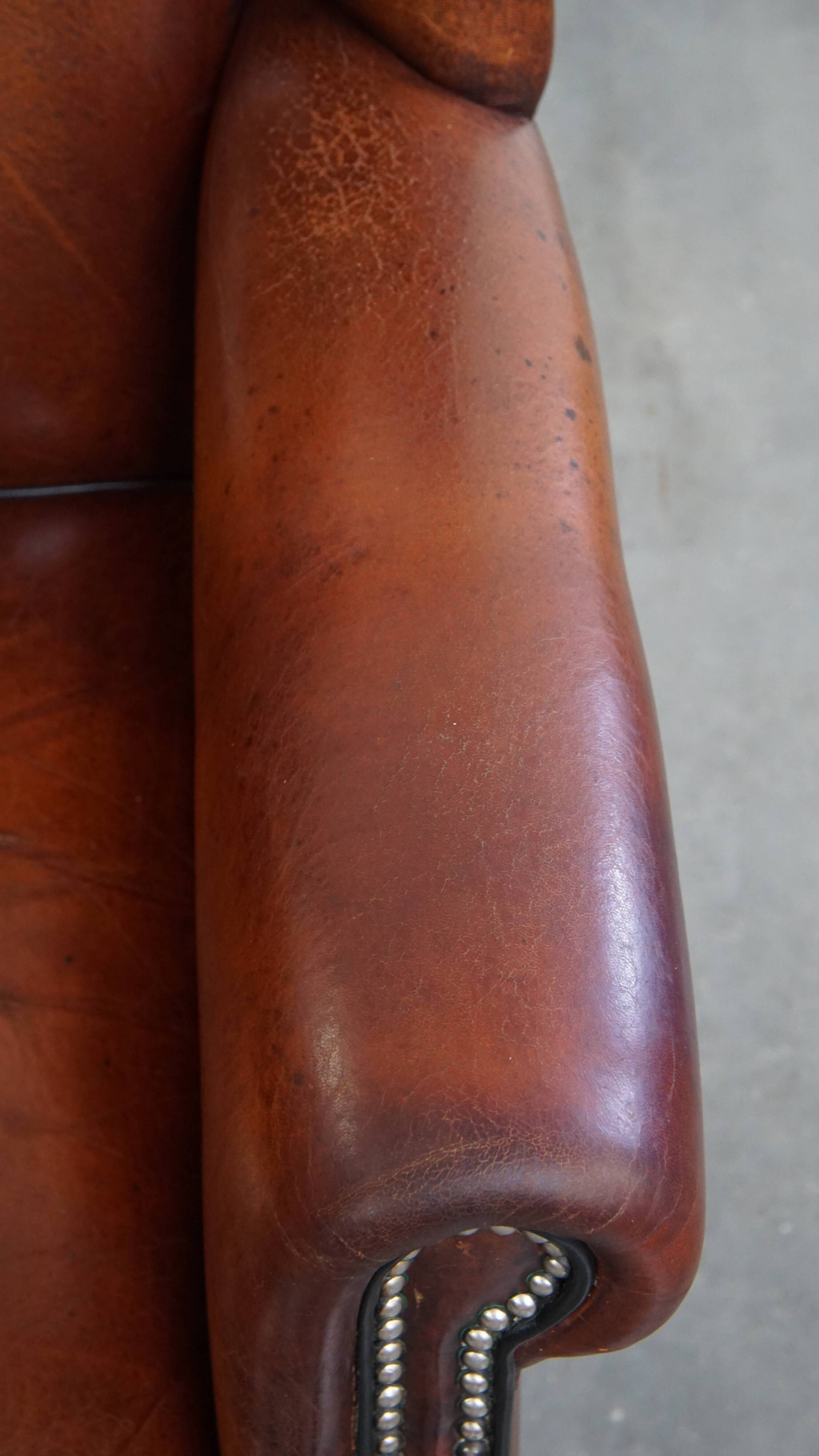 Sheepskin Wingback Chair with Warm Tones and Black Piping