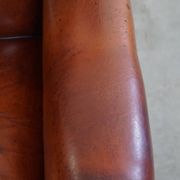 Sheepskin Wingback Chair with Warm Tones and Black Piping