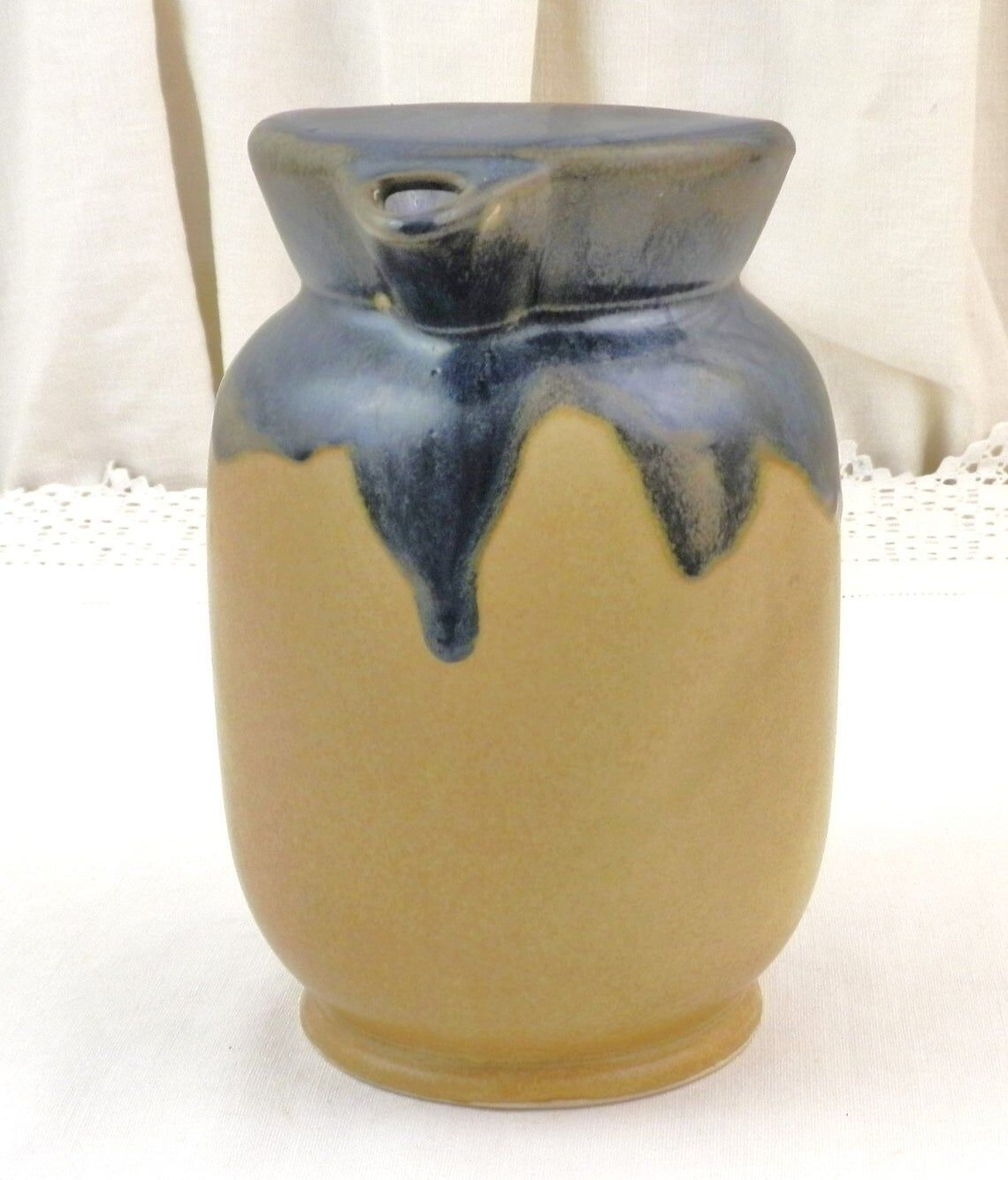 Vintage art deco water pitcher with drippy dark blue glaze.