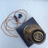 Brass lamp surrounded by leather with lampshade