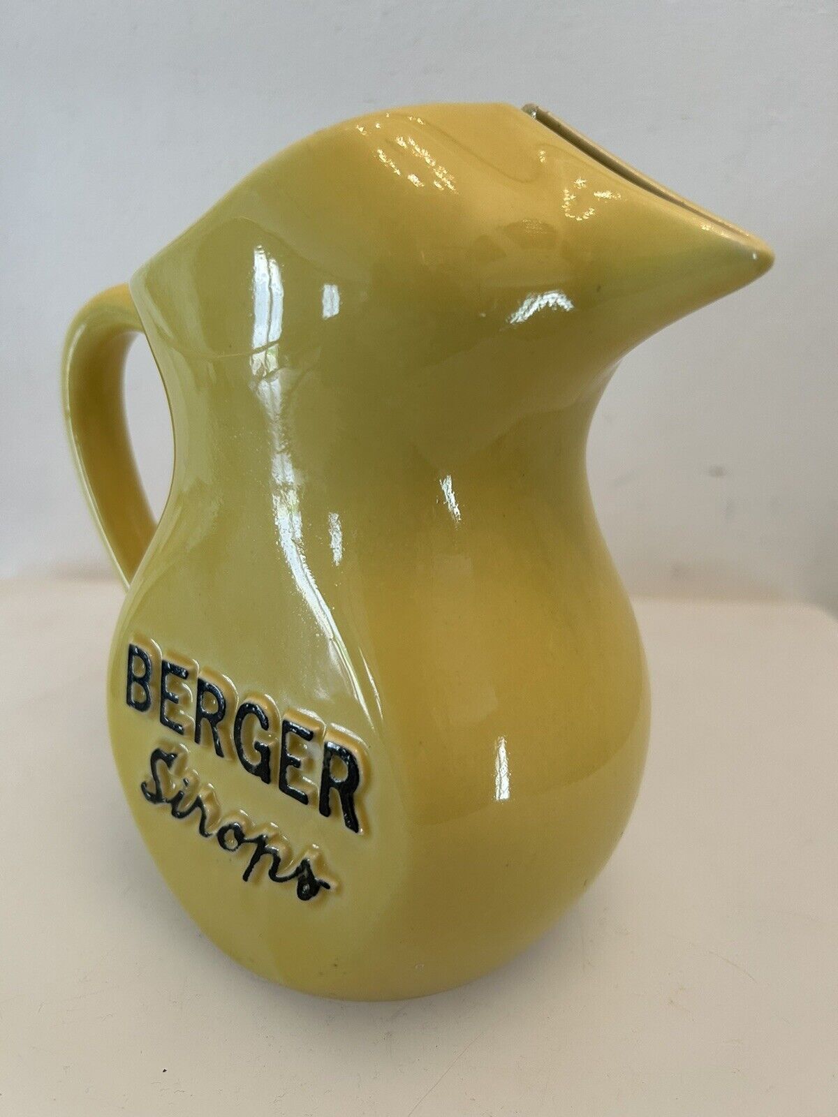 Old yellow pitcher anisette berger syrups, vintage bistro decoration