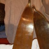 pair of vintage wooden Skis and their bats.