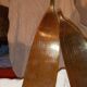 pair of vintage wooden Skis and their bats.