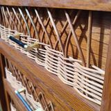 Tall chest of drawers in wood and rattan with splayed legs