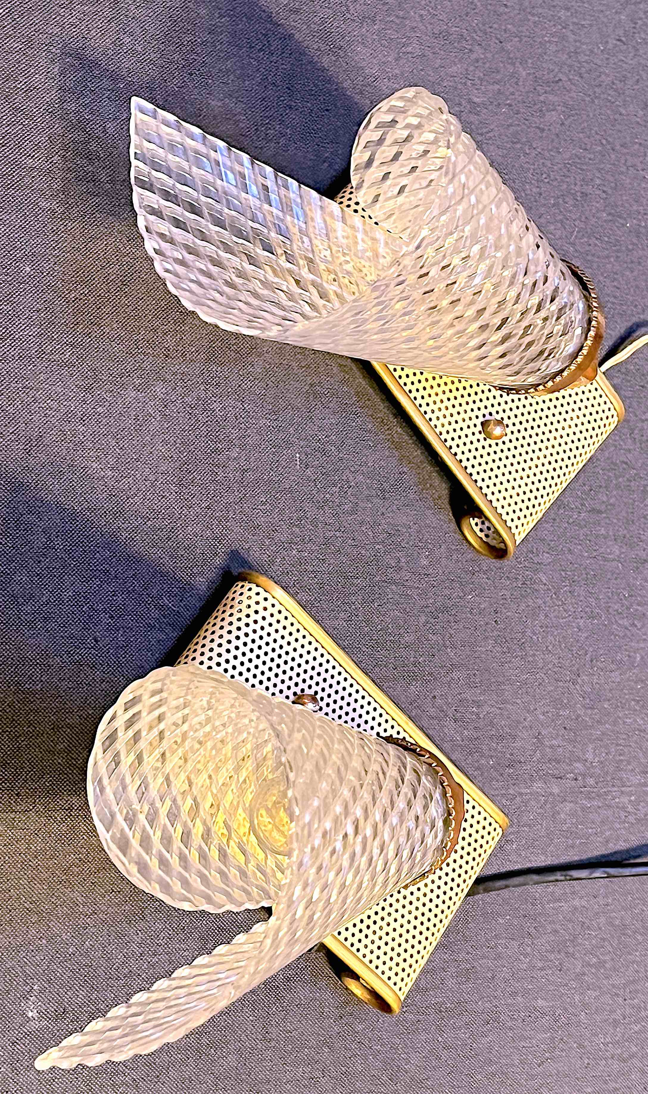 Pair of brass sconces, perforated metal and perhapx conical lampshade, France 50's