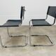 Paire de chaises cantilever simili cuir noir et chrome