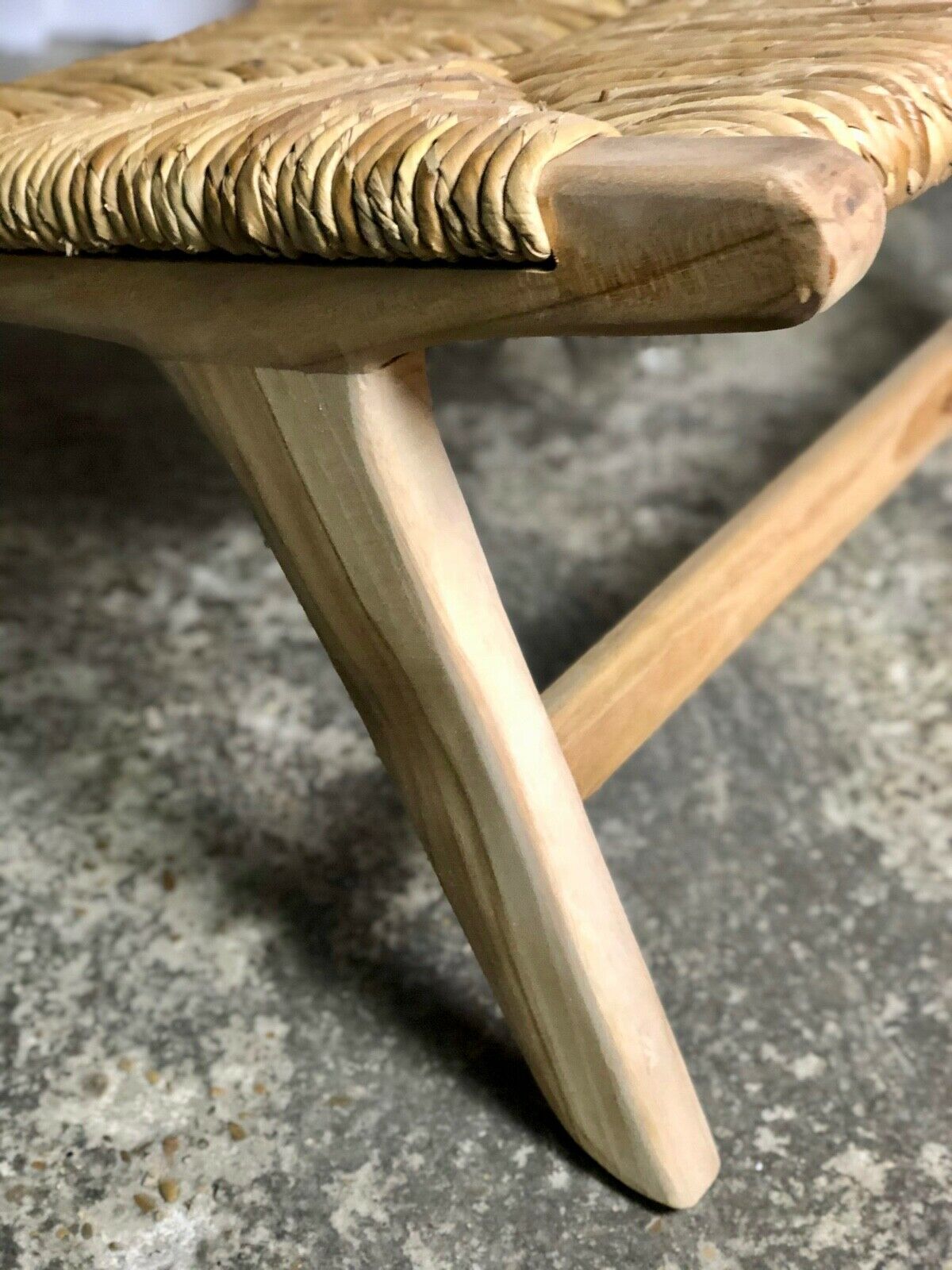 Low armchair in raw teak with seat and mulched backrest