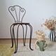 Small chair / stool in twisted wrought iron and floral ceramic.