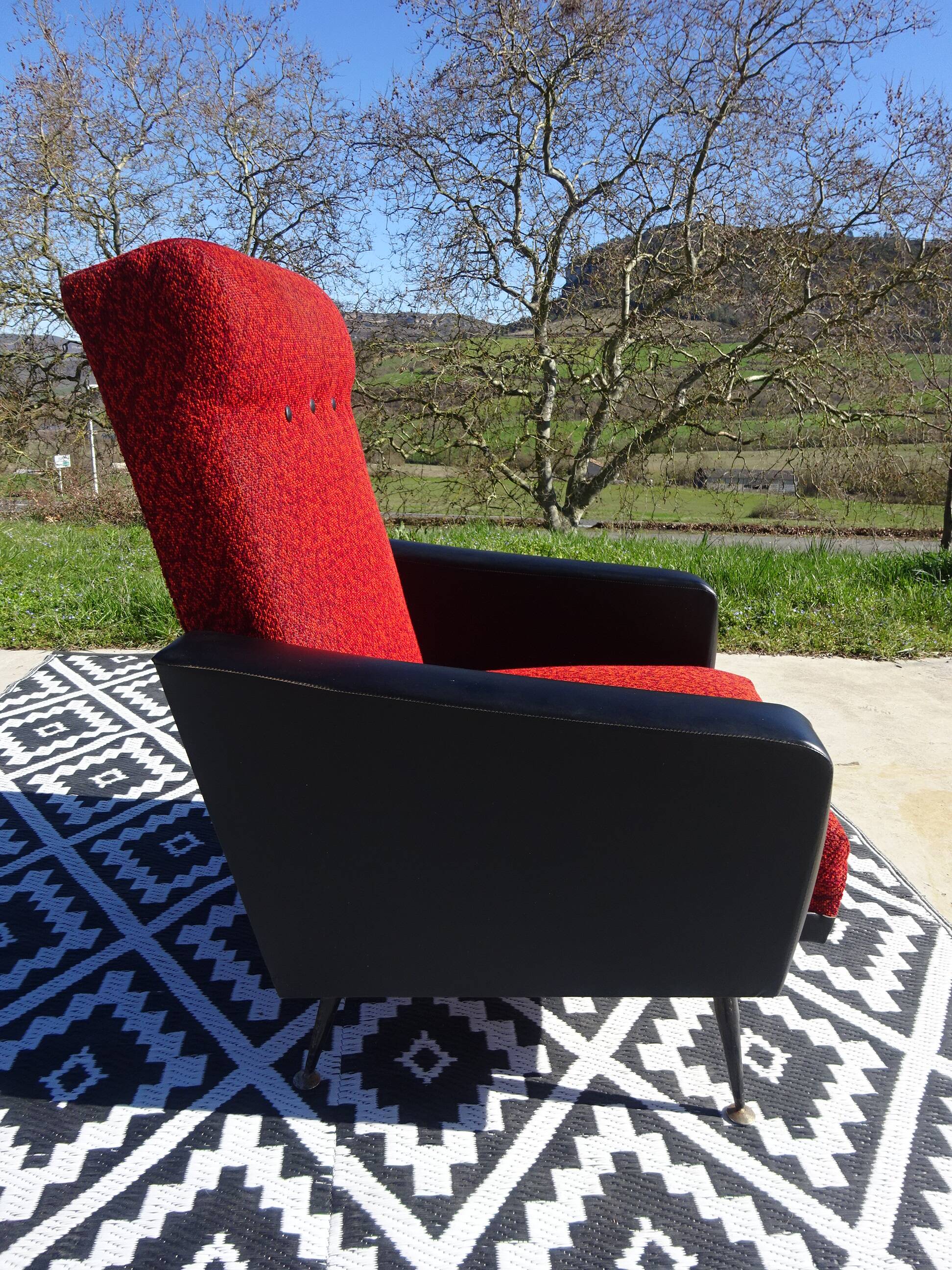 Vintage armchairs in red and black faux leather, the pair.