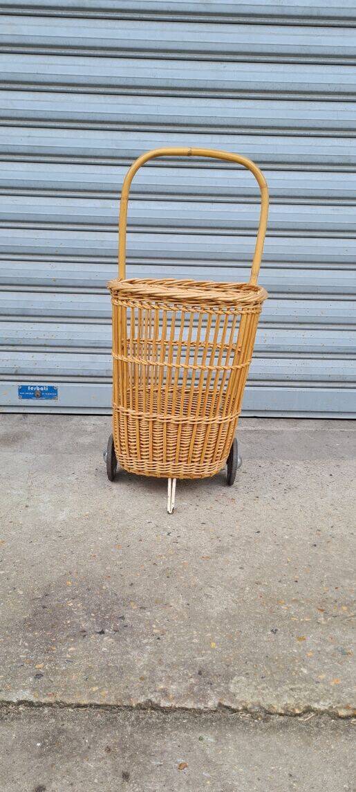 Vintage wicker log basket on vintage wheels