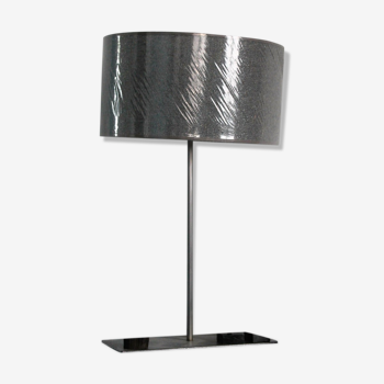 Metal lamp with metallic grey lampshade and with magnetized African wooden statuettes