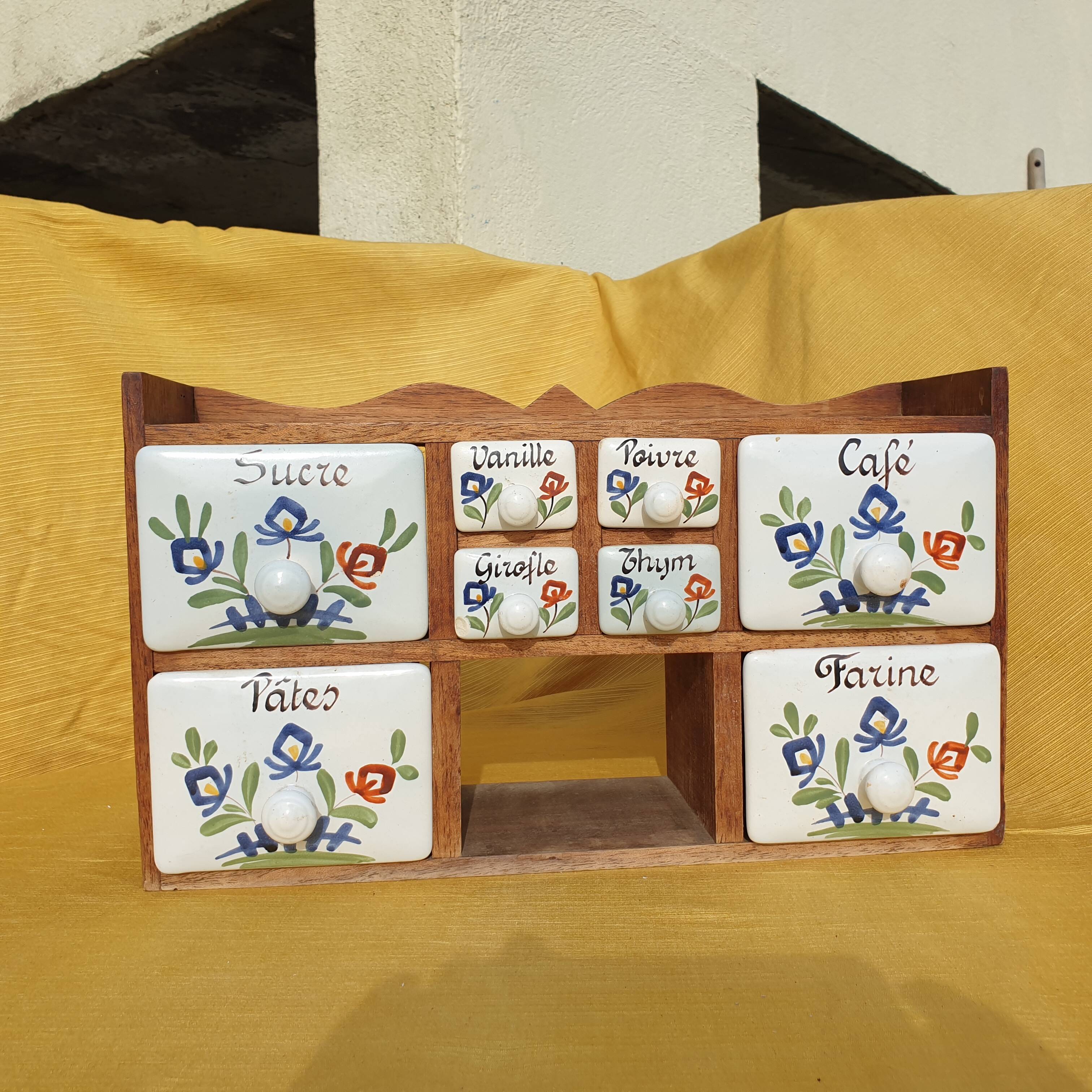 Vintage wooden spice rack with ceramic drawers