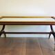 Patinated and gilded carved wooden coffee table. Hirch House.