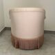 Pink armchair with patterns and fringes.