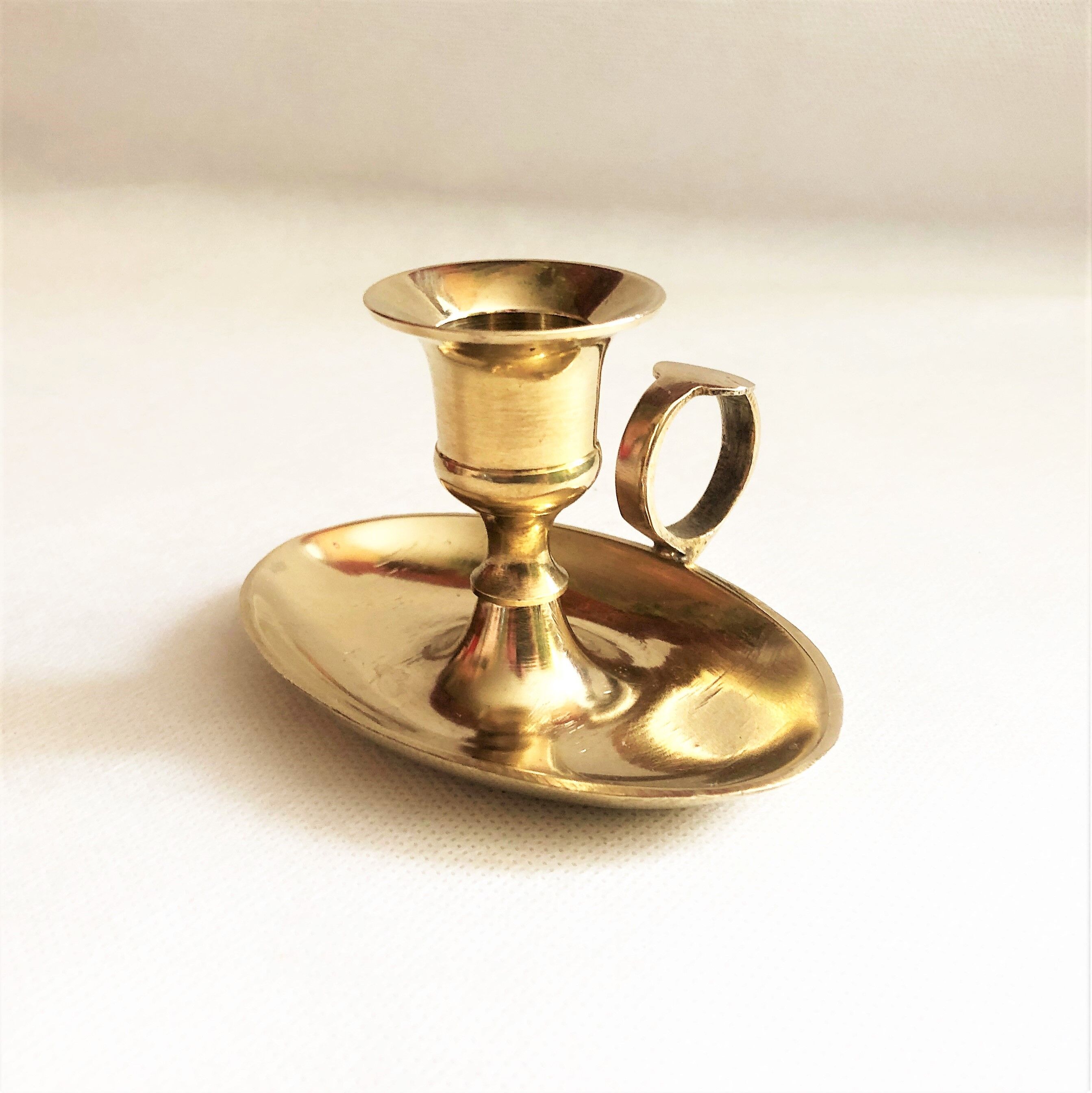 Brass oval hand candle holder