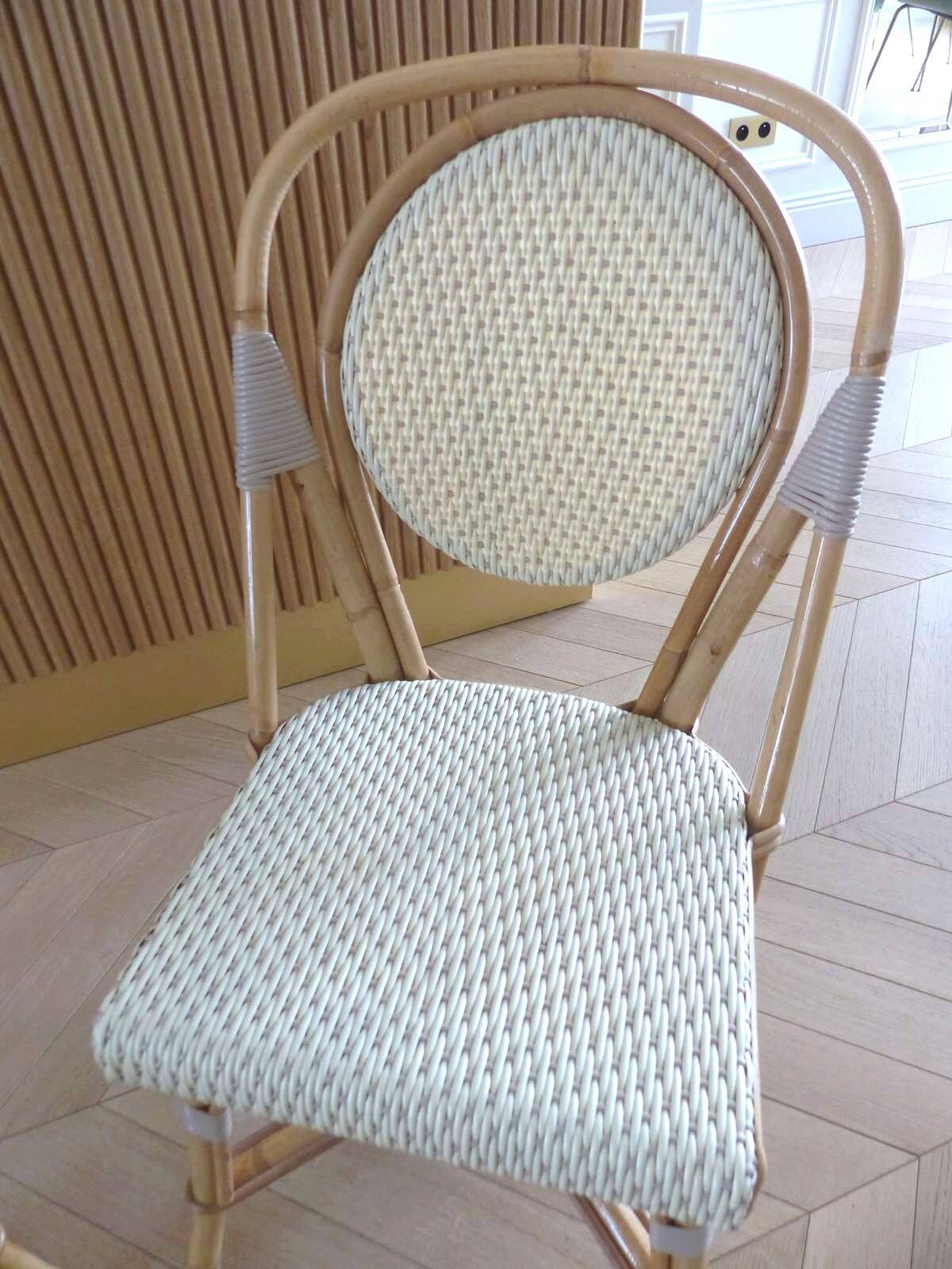 Pair of Parisian bistro chairs from Maison Louis Drucker in light Manila rattan.