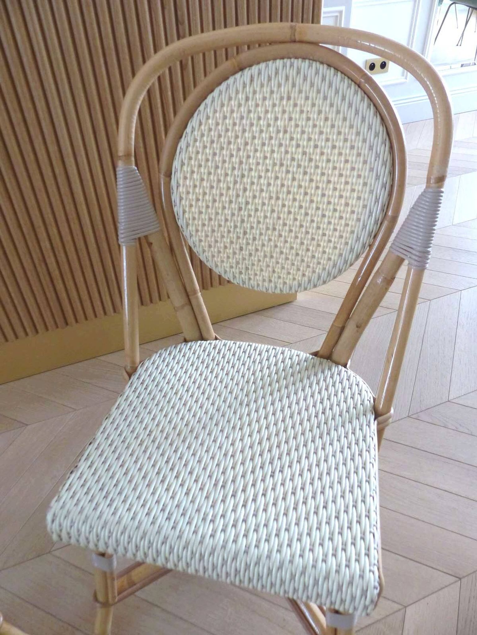 Pair of Parisian bistro chairs from Maison Louis Drucker in light Manila rattan.