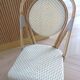 Pair of Parisian bistro chairs from Maison Louis Drucker in light Manila rattan.