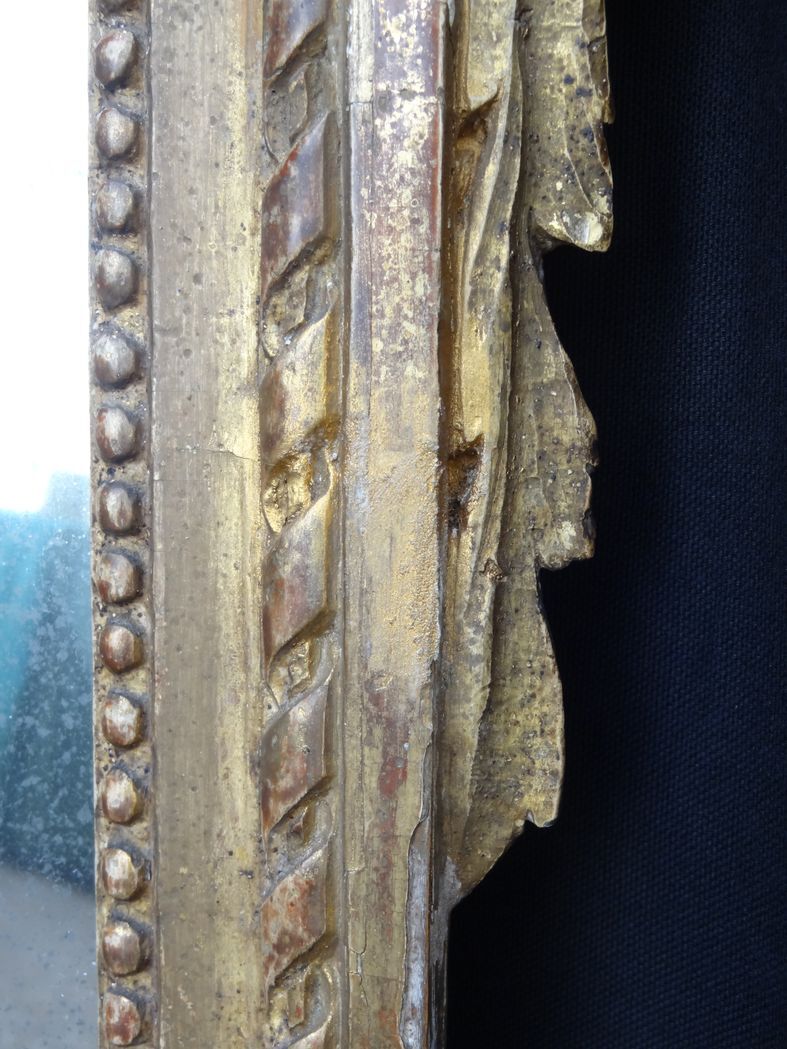 Louis XVI period mirror in gilded carved wood
