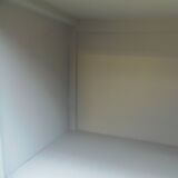 Vintage furniture of shallow depth re-enchanted in grey-green.