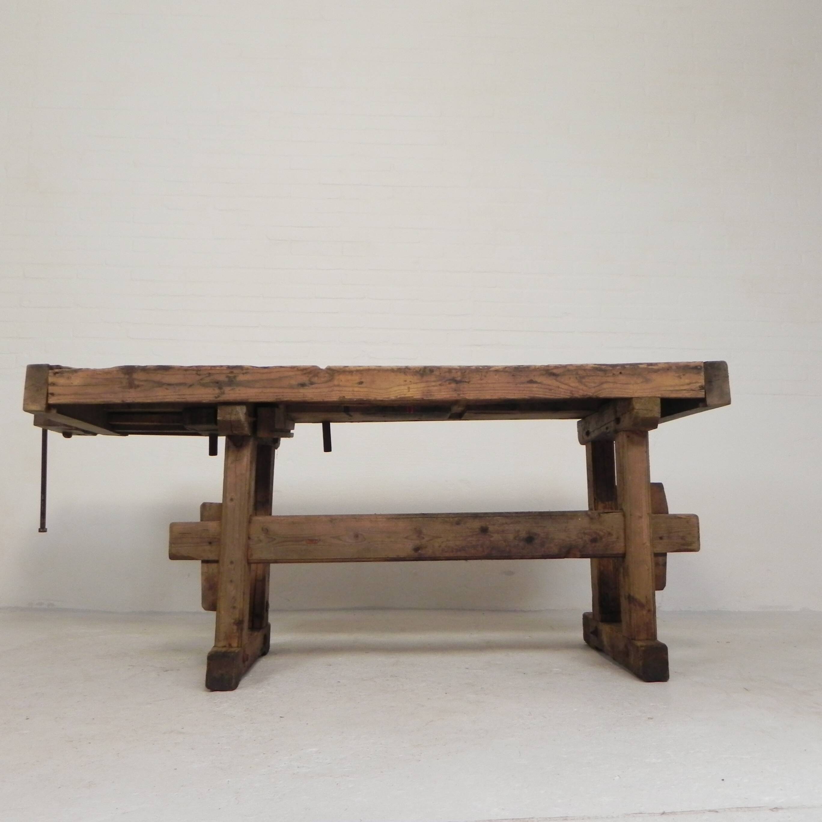 Wooden industrial workbench with vice, 194 cm long, 1930s.