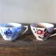 A set of 2 Digoin Sarreguemines cups with pink and blue flowers.