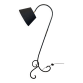 Design floor lamp in black lacquered metal and brass.